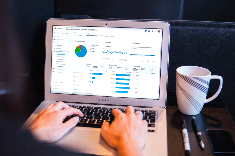 Person researching user metrics on laptop to help with increasing organic traffic